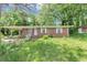 Charming single-story brick home with a covered porch and well-maintained front yard landscaping at 844 Oak Nw St, Atlanta, GA 30318