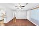 Empty living room featuring hardwood floors, a ceiling fan, and a view into the kitchen at 844 Oak Nw St, Atlanta, GA 30318