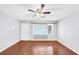 Empty living room featuring hardwood floors, a ceiling fan, and a front-facing window at 844 Oak Nw St, Atlanta, GA 30318