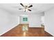 Empty living room featuring hardwood floors, a ceiling fan, and a view into the kitchen at 844 Oak Nw St, Atlanta, GA 30318
