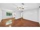 Empty living room featuring hardwood floors, a ceiling fan, and a view into the kitchen at 844 Oak Nw St, Atlanta, GA 30318