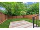 Private backyard with a wooden deck and lush green lawn, perfect for outdoor activities at 308 Mcpherson Se Pl, Atlanta, GA 30316