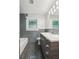 Modern bathroom features gray tiling, a sleek vanity, and contemporary fixtures at 308 Mcpherson Se Pl, Atlanta, GA 30316