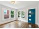 Bright entryway featuring hardwood floors, white trim, and a stylish teal door with geometric accents at 308 Mcpherson Se Pl, Atlanta, GA 30316