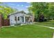 Inviting home with a manicured lawn, covered porch, and classic architectural details on a sunny day at 308 Mcpherson Se Pl, Atlanta, GA 30316