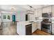 Open kitchen with stainless steel appliances, a bright quartz countertop island, and seamless access to the living area at 308 Mcpherson Se Pl, Atlanta, GA 30316