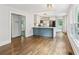 Open living room with hardwood floors, an eat-in kitchen, and plenty of natural light from windows at 308 Mcpherson Se Pl, Atlanta, GA 30316