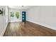 Hardwood floors and a stylish blue door create an inviting living space with abundant natural light at 308 Mcpherson Se Pl, Atlanta, GA 30316