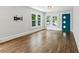 Bright living room with hardwood floors, large windows, and a stylish blue door offering modern charm at 308 Mcpherson Se Pl, Atlanta, GA 30316