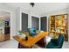 Home office with a vintage desk, teal chair, and a built-in bookshelf at 308 Mcpherson Se Pl, Atlanta, GA 30316