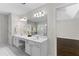 Bright bathroom boasts double vanity and a large mirror at 3335 Ashton Dr, Suwanee, GA 30024