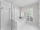 Well-lit bathroom offers a shower, tub, and bright windows at 3335 Ashton Dr, Suwanee, GA 30024