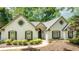Charming white brick home featuring a well-manicured lawn and mature trees at 3335 Ashton Dr, Suwanee, GA 30024