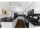 Bright kitchen featuring granite countertops, stainless steel appliances, and a functional center island with seating at 3335 Ashton Dr, Suwanee, GA 30024