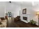 Inviting living room with dark hardwood floors, a marble fireplace, and a large, decorative front door at 3335 Ashton Dr, Suwanee, GA 30024