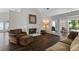 Cozy living room with hardwood floors, a fireplace, and comfortable seating at 3335 Ashton Dr, Suwanee, GA 30024