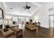 Spacious living room with hardwood floors, a ceiling fan, and great natural light from adjacent sunroom at 3335 Ashton Dr, Suwanee, GA 30024