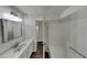 Bright bathroom featuring a modern vanity with a sleek white countertop and a separate tub area at 3445 Huntington Ct, Douglasville, GA 30134