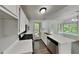 The kitchen has white cabinetry, stainless steel appliances, and a breakfast bar with a door to the backyard at 3445 Huntington Ct, Douglasville, GA 30134