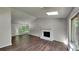 Bright living room featuring a fireplace, vaulted ceiling, skylight, and wood floors at 3445 Huntington Ct, Douglasville, GA 30134