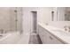 Bathroom with dual sinks, white cabinets, a glass shower, and a freestanding tub at 3611 Ridgeway Rd, Duluth, GA 30096
