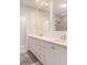 Bathroom with double sinks, white cabinets, two mirrors and an open door at 3611 Ridgeway Rd, Duluth, GA 30096