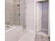 Bathroom with dual sinks, white cabinets, a glass shower, and a freestanding tub at 3611 Ridgeway Rd, Duluth, GA 30096