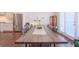 Dining room with a large wooden table, stainless steel refrigerator, and lots of light at 3611 Ridgeway Rd, Duluth, GA 30096