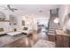 Open floor plan with a living area with white sofas, a staircase, and a bright, modern kitchen at 3611 Ridgeway Rd, Duluth, GA 30096