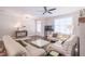 Bright living room with modern furnishings, neutral tones, and a ceiling fan at 3611 Ridgeway Rd, Duluth, GA 30096