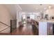 Open-concept living space with hardwood floors, kitchen island, and staircase at 3611 Ridgeway Rd, Duluth, GA 30096