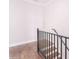 Staircase featuring wood flooring, white trim, black railing, and landing at 3611 Ridgeway Rd, Duluth, GA 30096