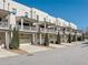 View of townhomes with decks, garages, and landscaping, on a sunny day at 3611 Ridgeway Rd, Duluth, GA 30096