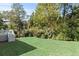 Expansive backyard with a well-maintained lawn and mature trees, with steps leading to a deck at 435 Webb Dr, Norcross, GA 30071