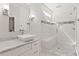 Bathroom featuring a glass shower, stone tiling, and white marble counters and cabinets at 435 Webb Dr, Norcross, GA 30071