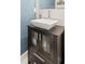 Bathroom vanity with square sink and storage cabinet with frosted glass panels, set against a patterned wall at 435 Webb Dr, Norcross, GA 30071