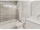 Bright bathroom showcasing a white vanity, marble countertop, toilet, and a tiled shower with glass doors at 435 Webb Dr, Norcross, GA 30071
