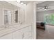 Bathroom with marble countertops, dual sinks, and a view into the bedroom at 435 Webb Dr, Norcross, GA 30071