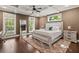 Primary bedroom features a ceiling fan, stylish rug, a large mirror and ample natural light at 435 Webb Dr, Norcross, GA 30071