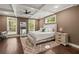 Primary bedroom features a ceiling fan, stylish rug, a large mirror and ample natural light at 435 Webb Dr, Norcross, GA 30071
