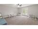 Spacious bonus room featuring neutral carpet, a ceiling fan, and double doors leading to the outside at 435 Webb Dr, Norcross, GA 30071