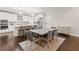 Open-concept dining room with island kitchen, modern lighting, and stainless steel appliances at 435 Webb Dr, Norcross, GA 30071