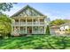 Charming two-story home featuring a double front porch and lush green lawn at 435 Webb Dr, Norcross, GA 30071