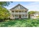 Charming two-story home featuring a double front porch and lush green lawn at 435 Webb Dr, Norcross, GA 30071