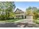 Elegant two-story house showcasing mature landscaping, a spacious front lawn and a side entry garage at 435 Webb Dr, Norcross, GA 30071