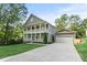 A stately two-story home with a wide driveway and lush, mature trees at 435 Webb Dr, Norcross, GA 30071