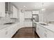 Contemporary kitchen offers white cabinetry, stainless steel appliances, granite countertops, and hardwood flooring at 435 Webb Dr, Norcross, GA 30071