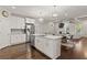 Open concept kitchen with island, stainless appliances, and connecting living area with coffered ceiling at 435 Webb Dr, Norcross, GA 30071