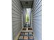 Narrow side yard between two houses with stone pavers and gravel leading to a small patch of greenery at 435 Webb Dr, Norcross, GA 30071