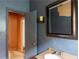 Bathroom featuring a vanity with a sink, a framed mirror, and partial view into another room at 1388 Metropolitan Se Ave, Atlanta, GA 30316